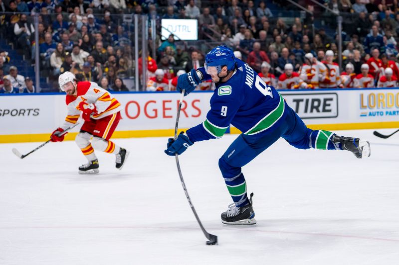 Apr 16, 2024; Vancouver, British Columbia, CAN; Vancouver Canucks forward J.T. Miller (9) scores on this shot against the Calgary Flames in the third period at Rogers Arena. Canucks won 4 -1. Mandatory Credit: Bob Frid-USA TODAY Sports