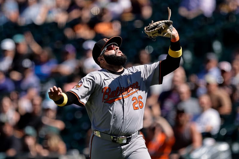 Sep 1, 2024; Denver, Colorado, USA; Baltimore Orioles first baseman Emmanuel Rivera (26) catches a pop fly for an out in the fourth inning against the Colorado Rockies at Coors Field. Mandatory Credit: Isaiah J. Downing-USA TODAY Sports