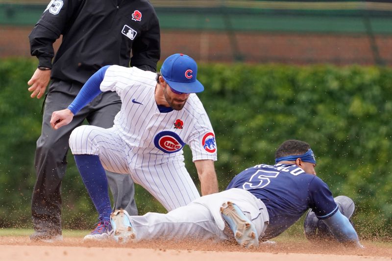 May 29, 2023; Chicago, Illinois, USA; Tampa Bay Rays shortstop Wander Franco (5) steals second base as Chicago Cubs shortstop Dansby Swanson (7) makes a late tag during the seventh inning at Wrigley Field. Mandatory Credit: David Banks-USA TODAY Sports