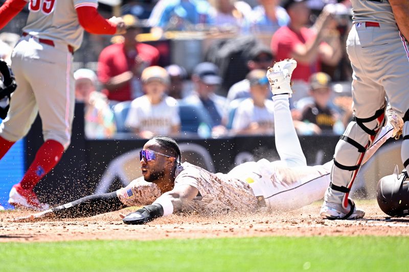 Apr 28, 2024; San Diego, California, USA; San Diego Padres left fielder Jurickson Profar (10) slides home to score a run against the Philadelphia Phillies during the third inning at Petco Park. Mandatory Credit: Orlando Ramirez-USA TODAY Sports