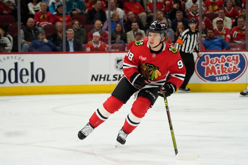 Oct 17, 2024; Chicago, Illinois, USA; Chicago Blackhawks center Connor Bedard (98) skates against the San Jose Sharks during the third period at United Center. Mandatory Credit: David Banks-Imagn Images