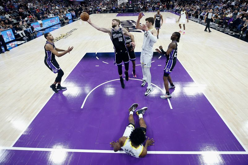 SACRAMENTO, CALIFORNIA - MARCH 31: Domantas Sabonis #10 of the Sacramento Kings goes for a rebound in the fourth quarter against the Utah Jazz at Golden 1 Center on March 31, 2024 in Sacramento, California. NOTE TO USER: User expressly acknowledges and agrees that, by downloading and or using this photograph, User is consenting to the terms and conditions of the Getty Images License Agreement. (Photo by Lachlan Cunningham/Getty Images)