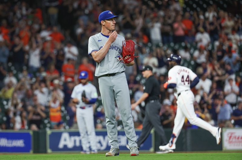 Apr 3, 2024; Houston, Texas, USA; Toronto Blue Jays starting pitcher Chris Bassitt (40) reacts and Houston Astros left fielder Yordan Alvarez (44) rounds the bases after hitting a home run during the third inning at Minute Maid Park. Mandatory Credit: Troy Taormina-USA TODAY Sports