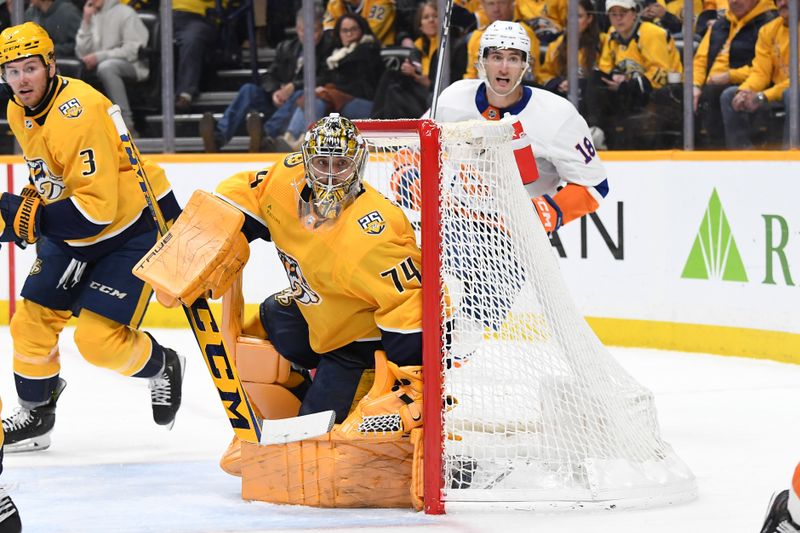 Jan 13, 2024; Nashville, Tennessee, USA; Nashville Predators goaltender Juuse Saros (74) watches the puck in the corner during the second period against the New York Islanders at Bridgestone Arena. Mandatory Credit: Christopher Hanewinckel-USA TODAY Sports