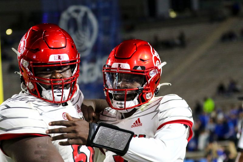 Nov 18, 2021; Durham, North Carolina, USA;  Louisville Cardinals offensive lineman Renato Brown (56) and quarterback Malik Cunningham (3) celebrate a touchdown during the 1st half of the game against the Louisville Cardinals at Wallace Wade Stadium. Mandatory Credit: Jaylynn Nash-USA TODAY Sports