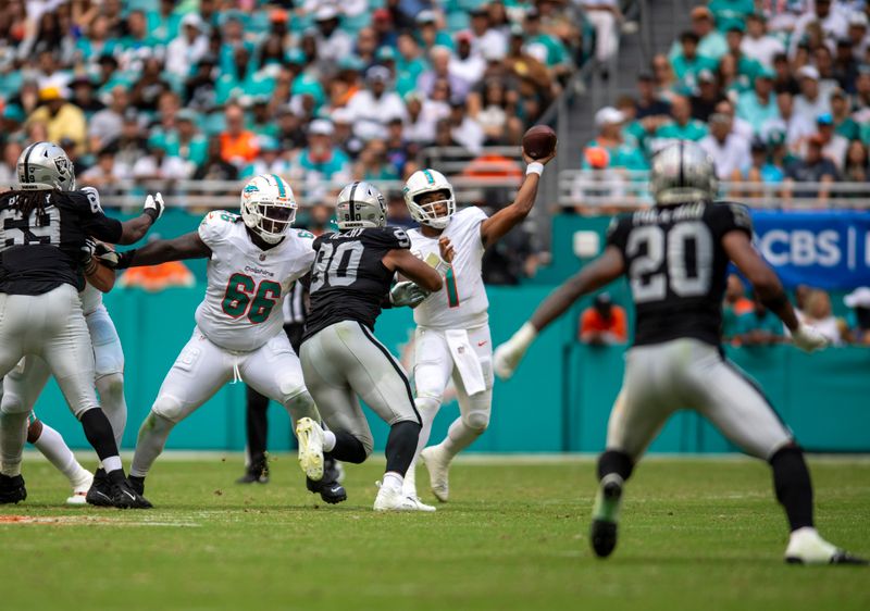 Miami Dolphins quarterback Tua Tagovailoa (1) throws a pass during the second half of an NFL football game against the Las Vegas Raiders, Sunday, Nov. 19, 2023, in Miami Gardens, Fla. (AP Photo/Michael Laughlin)