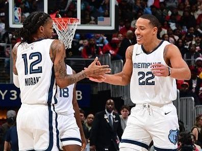 ATLANTA, GA - DECEMBER 23: Ja Morant #12 and Desmond Bane #22 of the Memphis Grizzlies high five during the game against the Atlanta Hawks on December 23, 2023 at State Farm Arena in Atlanta, Georgia.  NOTE TO USER: User expressly acknowledges and agrees that, by downloading and/or using this Photograph, user is consenting to the terms and conditions of the Getty Images License Agreement. Mandatory Copyright Notice: Copyright 2023 NBAE (Photo by Scott Cunningham/NBAE via Getty Images)