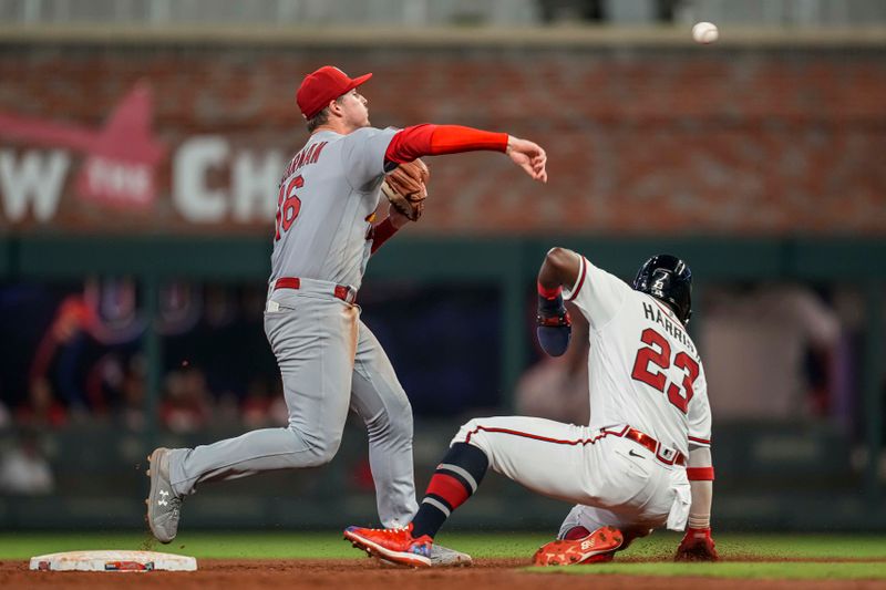 Sep 6, 2023; Cumberland, Georgia, USA; St. Louis Cardinals second baseman Nolan Gorman (16) turns a double play over Atlanta Braves center fielder Michael Harris II (23) during the sixth inning at Truist Park. Mandatory Credit: Dale Zanine-USA TODAY Sports