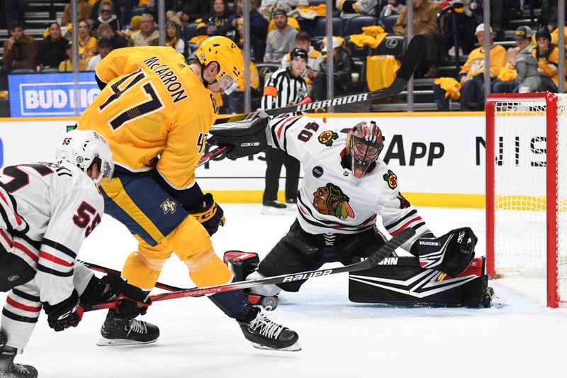 Jan 2, 2024; Nashville, Tennessee, USA; Chicago Blackhawks goaltender Arvid Soderblom (40) waits to block a shot by Nashville Predators right wing Michael McCarron (47) during the first period at Bridgestone Arena. Mandatory Credit: Christopher Hanewinckel-USA TODAY Sports