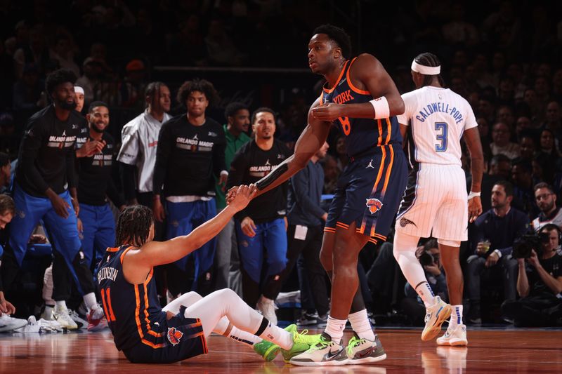 NEW YORK, NY - DECEMBER 3: OG Anunoby #8 helps up Jalen Brunson #11 of the New York Knicks during the game against the Orlando Magic during the Emirates NBA Cup on December 3, 2024 at Madison Square Garden in New York City, New York.  NOTE TO USER: User expressly acknowledges and agrees that, by downloading and or using this photograph, User is consenting to the terms and conditions of the Getty Images License Agreement. Mandatory Copyright Notice: Copyright 2024 NBAE  (Photo by Nathaniel S. Butler/NBAE via Getty Images)