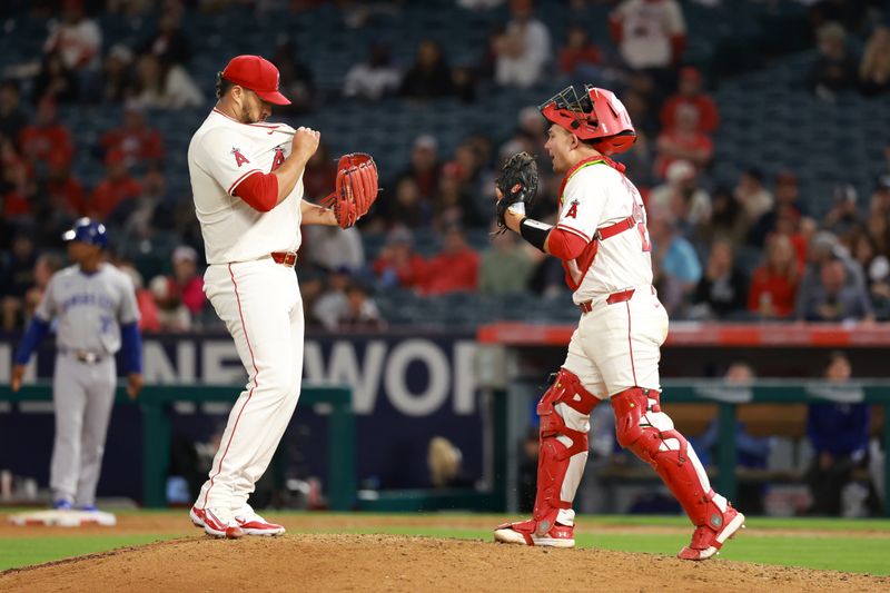 May 10, 2024; Anaheim, California, USA;  Los Angeles Angels catcher Matt Thaiss (21) conciliates pitcher Carlos Estevez (53) during the ninth inning against the Kansas City Royals at Angel Stadium. Mandatory Credit: Kiyoshi Mio-USA TODAY Sports