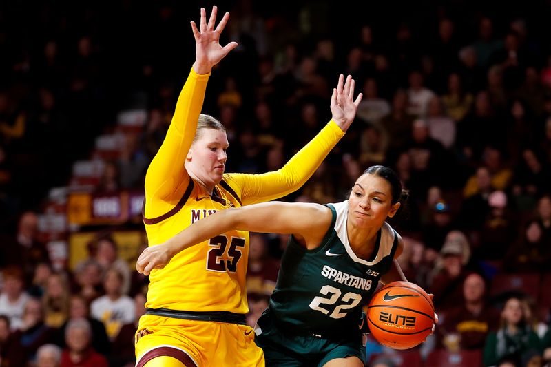 Jan 20, 2024; Minneapolis, Minnesota, USA; Michigan State Spartans guard Moira Joiner (22) works around Minnesota Golden Gophers guard Grace Grocholski (25) during the second half at Williams Arena. Mandatory Credit: Matt Krohn-USA TODAY Sports