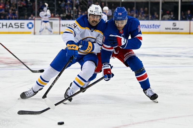 Nov 7, 2024; New York, New York, USA;  Buffalo Sabres right wing Alex Tuch (89) and New York Rangers defenseman K'Andre Miller (79) battle for the puck during the first period at Madison Square Garden. Mandatory Credit: Dennis Schneidler-Imagn Images