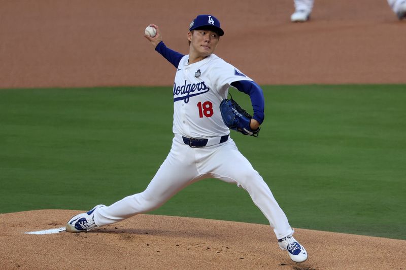 Oct 26, 2024; Los Angeles, California, USA; Los Angeles Dodgers pitcher Yoshinobu Yamamoto (18) throws a pitch against the New York Yankees in the first inning for game two of the 2024 MLB World Series at Dodger Stadium. Mandatory Credit: Kiyoshi Mio-Imagn Images