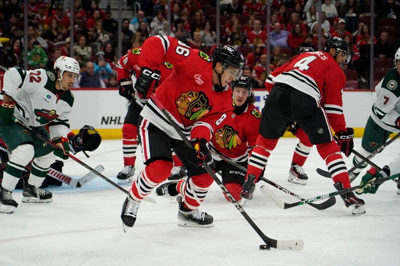 Oct 4, 2024; Chicago, Illinois, USA; Chicago Blackhawks center Teuvo Teravainen (86) clears the puck against the Minnesota Wild during the second period at United Center. Mandatory Credit: David Banks-Imagn Images