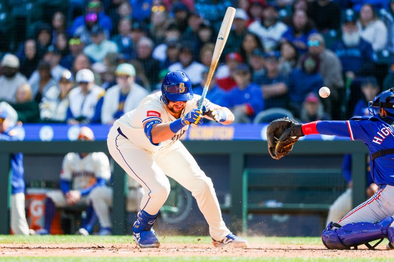 Apr 13, 2025; Seattle, Washington, USA; Seattle Mariners catcher Cal Raleigh (29) is hit by a pitch in the foot during the sixth inning against the Texas Rangers at T-Mobile Park. Mandatory Credit: Joe Nicholson-Imagn Images