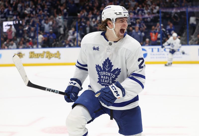 Apr 9, 2025; Tampa, Florida, USA; Toronto Maple Leafs left wing Matthew Knies (23) celebrates after scoring the winning goal against the Tampa Bay Lightning during overtime at Amalie Arena. Mandatory Credit: Kim Klement Neitzel-Imagn Images