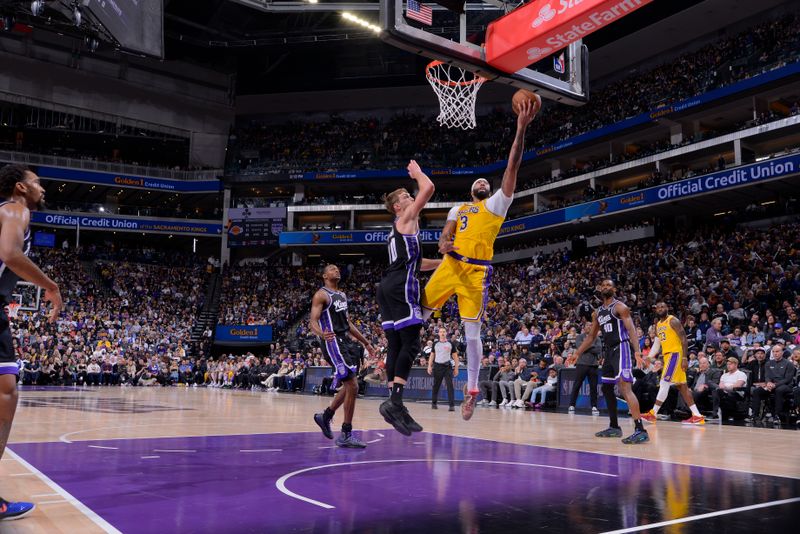 SACRAMENTO, CA - MARCH 13:  Anthony Davis #3 of the Los Angeles Lakers drives to the basket during the game against the Sacramento Kings on March 13, 2024 at Golden 1 Center in Sacramento, California. NOTE TO USER: User expressly acknowledges and agrees that, by downloading and or using this Photograph, user is consenting to the terms and conditions of the Getty Images License Agreement. Mandatory Copyright Notice: Copyright 2024 NBAE (Photo by Rocky Widner/NBAE via Getty Images)