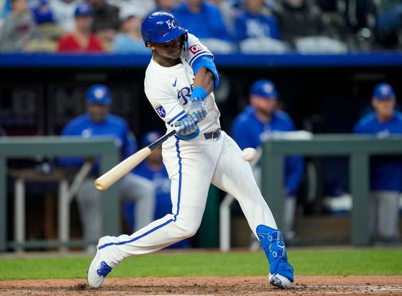 Apr 22, 2024; Kansas City, Missouri, USA; Kansas City Royals left fielder Dairon Blanco (44) hits a double during the sixth inning against the Toronto Blue Jays at Kauffman Stadium. Mandatory Credit: Jay Biggerstaff-USA TODAY Sports