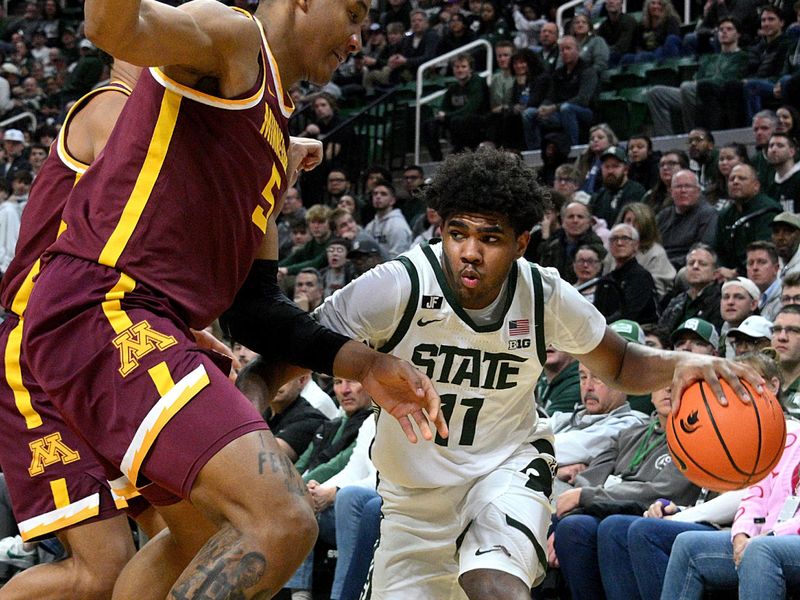 Jan 28, 2025; East Lansing, Michigan, USA;  Michigan State Spartans guard Jase Richardson (11) is defended by two Minnesota Golden Gophers defenders in the second half at Jack Breslin Student Events Center. Mandatory Credit: Dale Young-Imagn Images