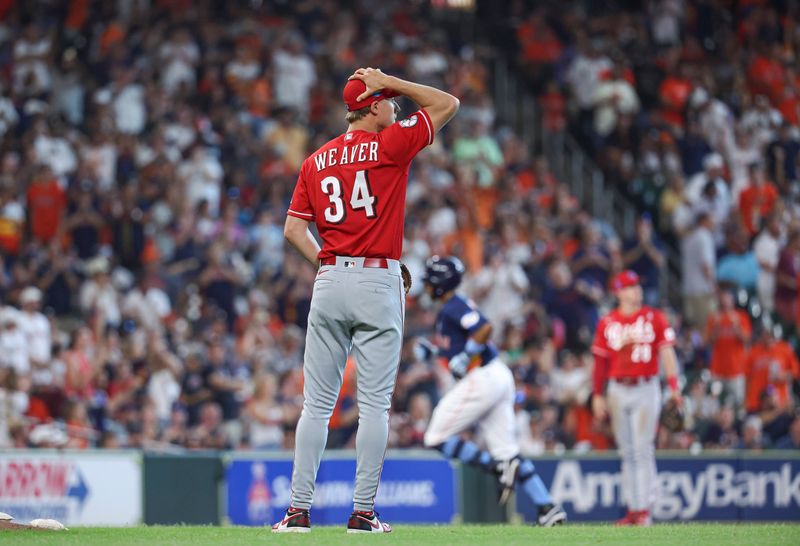 Jun 18, 2023; Houston, Texas, USA; Cincinnati Reds starting pitcher Luke Weaver (34) reacts and Houston Astros left fielder Corey Julks (9) rounds the bases after hitting a home run during the second inning at Minute Maid Park. Mandatory Credit: Troy Taormina-USA TODAY Sports