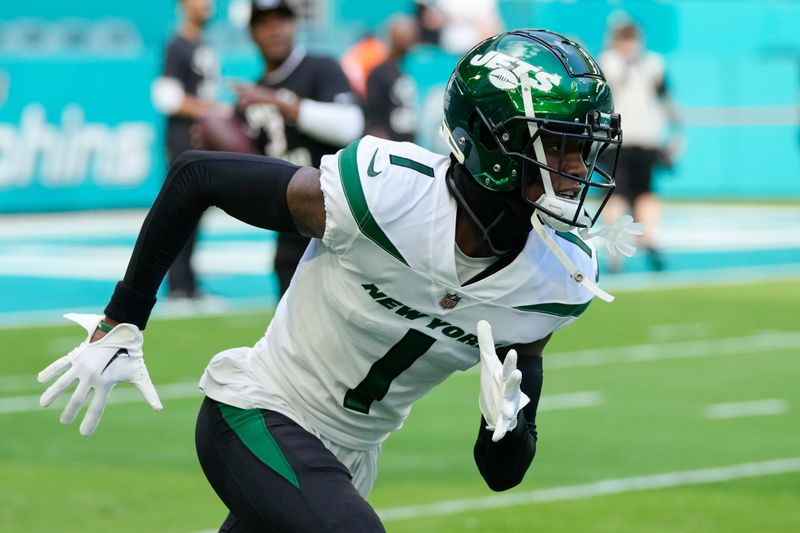 New York Jets cornerback Sauce Gardner (1) runs during a warm-up drill ahead of an NFL football game against the Miami Dolphins, Sunday, Jan. 8, 2023, in Miami Gardens, Fla. (AP Photo/Rebecca Blackwell)