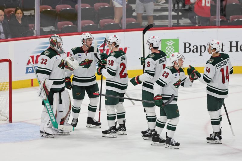 Oct 22, 2024; Sunrise, Florida, USA; Minnesota Wild goaltender Filip Gustavsson (32) celebrates with teammates after the game against the Florida Panthers at Amerant Bank Arena. Mandatory Credit: Sam Navarro-Imagn Images