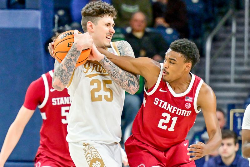 Mar 5, 2025; South Bend, Indiana, USA; Stanford Cardinal guard Jaylen Blakes (21) attempts to knock the ball away from Notre Dame Fighting Irish forward Nikita Konstantynovskyi (25) in the second half at the Purcell Pavilion. Mandatory Credit: Matt Cashore-Imagn Images