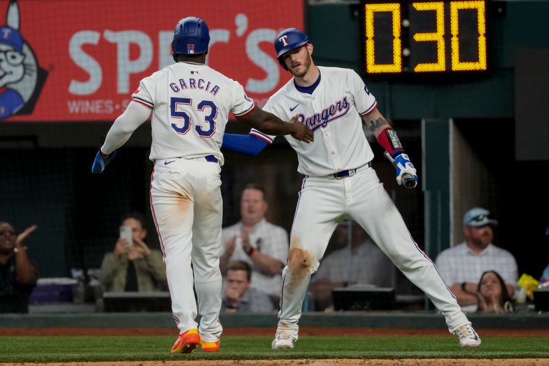 May 29, 2024; Arlington, Texas, USA; Texas Rangers right fielder Adolis Garcia (53) celebrates scoring with catcher Jonah Heim (28) against the Arizona Diamondbacks during the eighth inning at Globe Life Field. Mandatory Credit: Jim Cowsert-USA TODAY Sports