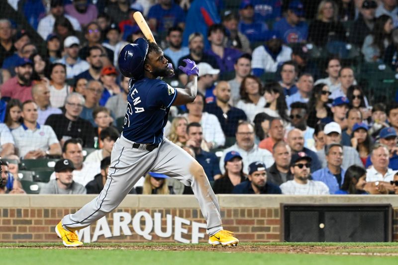 May 30, 2023; Chicago, Illinois, USA;  Tampa Bay Rays left fielder Randy Arozarena (56) hits an RBI single during the fifth inning against the Chicago Cubs at Wrigley Field. Mandatory Credit: Matt Marton-USA TODAY Sports