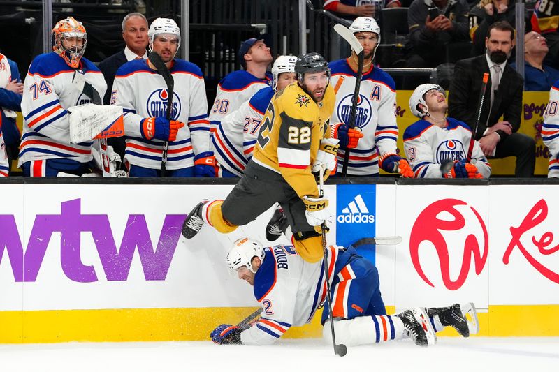 Feb 6, 2024; Las Vegas, Nevada, USA; Edmonton Oilers defenseman Evan Bouchard (2) trips up Vegas Golden Knights right wing Michael Amadio (22) during the third period at T-Mobile Arena. Mandatory Credit: Stephen R. Sylvanie-USA TODAY Sports