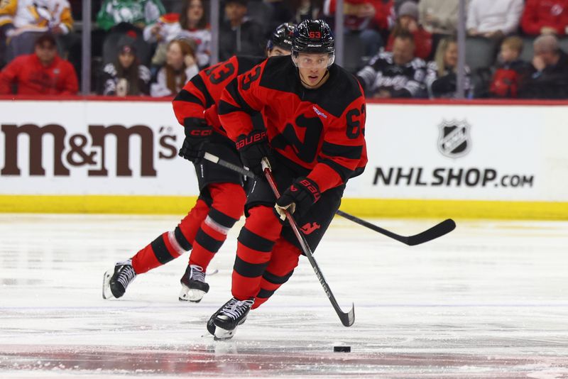 Mar 19, 2024; Newark, New Jersey, USA; New Jersey Devils left wing Jesper Bratt (63) skates with the puck against the Pittsburgh Penguins during the second period at Prudential Center. Mandatory Credit: Ed Mulholland-USA TODAY Sports