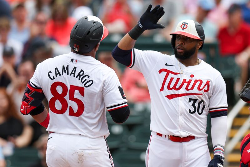 Mar 6, 2024; Fort Myers, Florida, USA;  Minnesota Twins catcher Jair Camargo (85) is congratulated by first baseman Carlos Santana (30) after hitting a two run home run against the Boston Red Sox in the fourth inning at Hammond Stadium. Mandatory Credit: Nathan Ray Seebeck-USA TODAY Sports