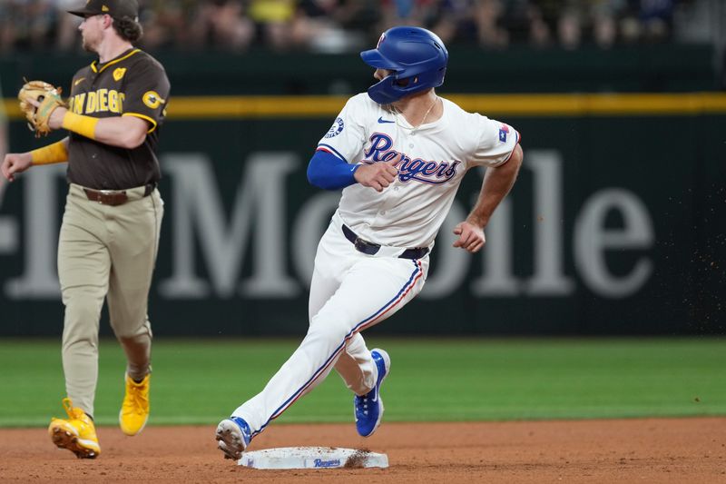 Jul 3, 2024; Arlington, Texas, USA; Texas Rangers left fielder Wyatt Langford (36) turns and looks as he rounds second base on a single hit by catcher Jonah Heim (28) against the San Diego Padres during the fourth inning at Globe Life Field. Mandatory Credit: Jim Cowsert-USA TODAY Sports