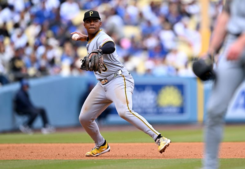 Apr 27, 2025; Los Angeles, California, USA; Pittsburgh Pirates third baseman Ke'Bryan Hayes (13) throws to first for an out during the third inning against the Los Angeles Dodgers at Dodger Stadium. Mandatory Credit: Jonathan Hui-Imagn Images