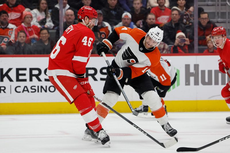 Jan 25, 2024; Detroit, Michigan, USA;  Philadelphia Flyers center Sean Couturier (14) skates with the puck defended by Detroit Red Wings defenseman Jeff Petry (46) in the third period at Little Caesars Arena. Mandatory Credit: Rick Osentoski-USA TODAY Sports