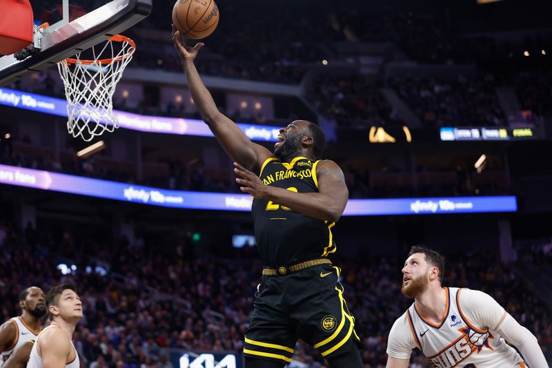 SAN FRANCISCO, CALIFORNIA - FEBRUARY 10: Draymond Green #23 of the Golden State Warriors goes to the basket against Jusuf Nurkic #20 of the Phoenix Suns in the fourth quarter at Chase Center on February 10, 2024 in San Francisco, California. NOTE TO USER: User expressly acknowledges and agrees that, by downloading and or using this photograph, User is consenting to the terms and conditions of the Getty Images License Agreement. (Photo by Lachlan Cunningham/Getty Images)