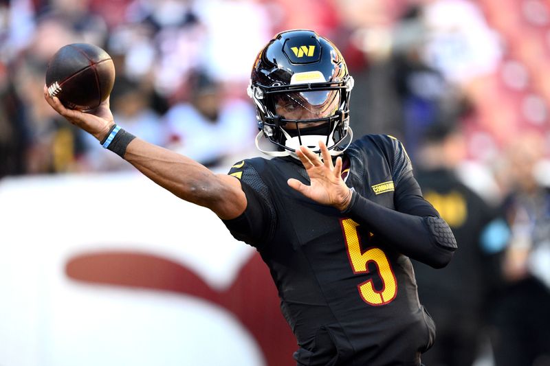 Washington Commanders quarterback Jayden Daniels warms up before an NFL football game against the Chicago Bears Sunday, Oct. 27, 2024, in Landover, Md. (AP Photo/Nick Wass)