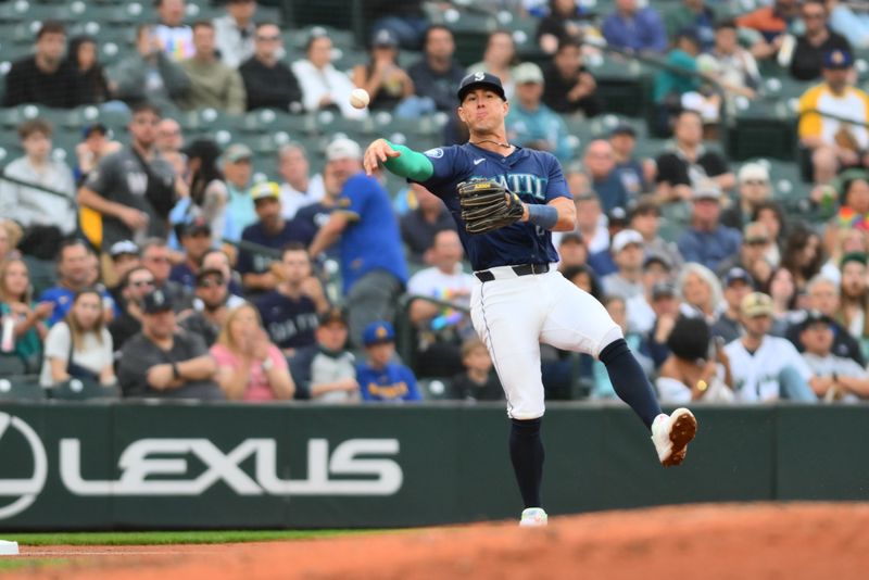 Jun 13, 2024; Seattle, Washington, USA; Seattle Mariners third baseman Dylan Moore (25) throws the ball to first base during the fourth inning against the Chicago White Sox at T-Mobile Park. Mandatory Credit: Steven Bisig-USA TODAY Sports