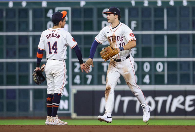 Jul 10, 2024; Houston, Texas, USA; Houston Astros right fielder Joey Loperfido (10) celebrates with left fielder Mauricio Dubon (14) after the game against the Miami Marlins at Minute Maid Park. Mandatory Credit: Troy Taormina-USA TODAY Sports