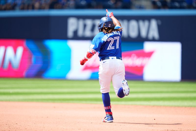 Jul 20, 2023; Toronto, Ontario, CAN; Toronto Blue Jays first baseman Vladimir Guerrero Jr. (27) hits a home run against the San Diego Padres during the seventh inning at Rogers Centre. Mandatory Credit: Kevin Sousa-USA TODAY Sports