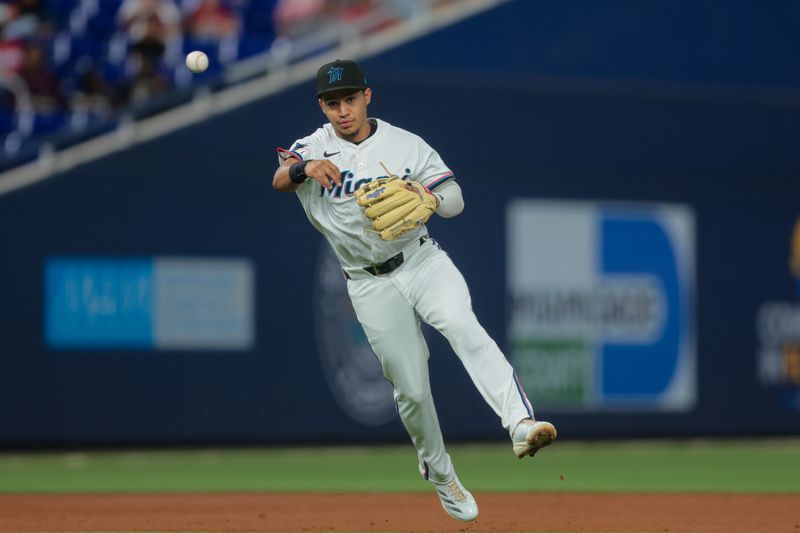 Jun 3, 2025; Miami, Florida, USA;  Miami Marlins second baseman Javier Sanoja (46) throws to first base to retire Colorado Rockies second baseman Thairo Estrada (not pictured) during the third inning at loanDepot Park. Mandatory Credit: Sam Navarro-Imagn Images