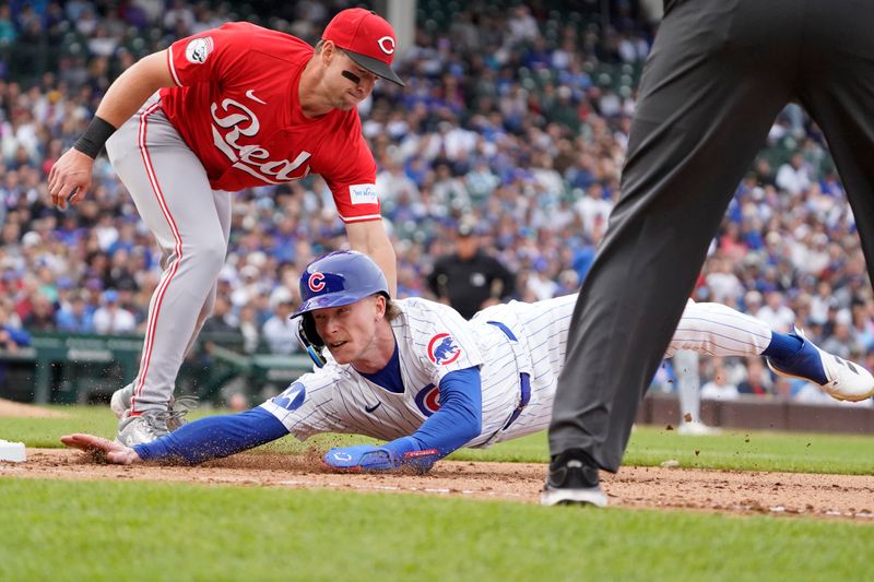 Sep 27, 2024; Chicago, Illinois, USA; Chicago Cubs outfielder Pete Crow-Armstrong (52) is picked off of first base as Cincinnati Reds first baseman Spencer Steer (7) tags him out during the eighth inning at Wrigley Field. Mandatory Credit: David Banks-Imagn Images