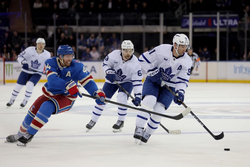 Mar 5, 2026; New York, New York, USA; Toronto Maple Leafs center John Tavares (91) controls the puck against New York Rangers defenseman Vladislav Gavrikov (44) during the third period at Madison Square Garden. Mandatory Credit: Brad Penner-Imagn Images Mar 5, 2026; New York, New York, USA; Toronto Maple Leafs center John Tavares (91) controls the puck against New York Rangers defenseman Vladislav Gavrikov (44) during the third period at Madison Square Garden. Mandatory Credit: Brad Penner-Imagn Images