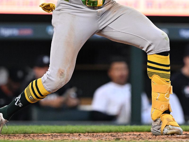 Jun 25, 2025; Detroit, Michigan, USA; Athletics center fielder Denzel Clarke (1) gets hit on the wrist by a pitch against the Detroit Tigers in the ninth inning at Comerica Park. Mandatory Credit: Lon Horwedel-Imagn Images