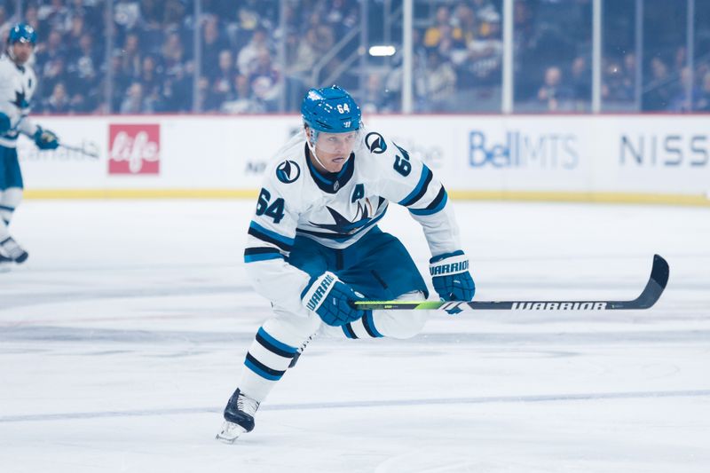 Oct 18, 2024; Winnipeg, Manitoba, CAN;  San Jose Sharks forward Mikael Granlund (64) skates into the Winnipeg Jets zone during the first period at Canada Life Centre. Mandatory Credit: Terrence Lee-Imagn Images