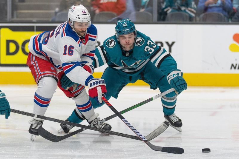 Jan 23, 2024; San Jose, California, USA; New York Rangers center Vincent Trocheck (16) and San Jose Sharks defenseman Calen Addison (33) fight for control of the puck during the first period at SAP Center at San Jose. Mandatory Credit: Stan Szeto-USA TODAY Sports