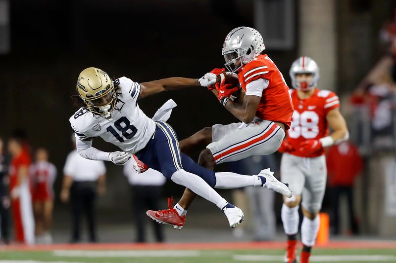Sep 25, 2021; Columbus, Ohio, USA; Ohio State Buckeyes wide receiver Garrett Wilson (5)makes the catch over Akron Zips cornerback A.J. Watts (18)during the second quarter at Ohio Stadium. Mandatory Credit: Joseph Maiorana-USA TODAY Sports
