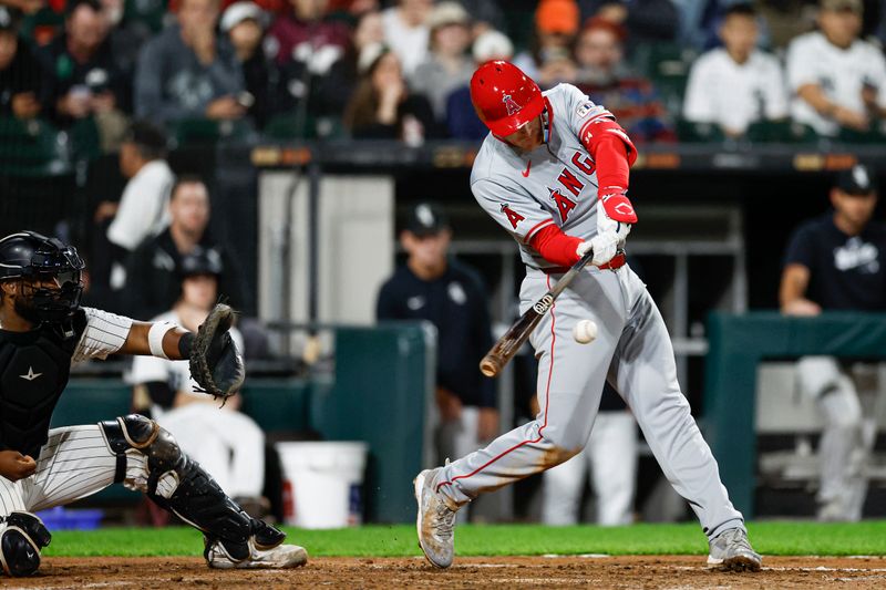 Sep 24, 2024; Chicago, Illinois, USA; Los Angeles Angels first baseman Eric Wagaman (34) hits an RBI-double against the Chicago White Sox during the seventh inning at Guaranteed Rate Field. Mandatory Credit: Kamil Krzaczynski-Imagn Images