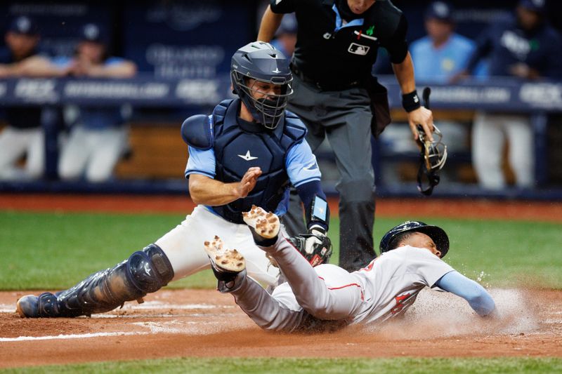 May 22, 2024; St. Petersburg, Florida, USA;  Boston Red Sox outfielder Ceddanne Rafaela (43) scores a run past Tampa Bay Rays catcher Ben Rortvedt (30) in the fifth inning at Tropicana Field. Mandatory Credit: Nathan Ray Seebeck-USA TODAY Sports